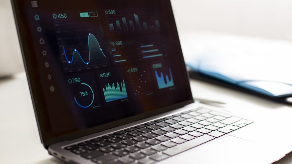 GEO tools: laptop showing a dashboard of metrics and charts