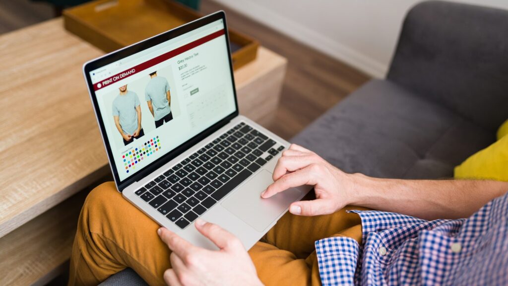 How to create a product page or service page: person on a sofa browsing a clothing product page on a laptop
